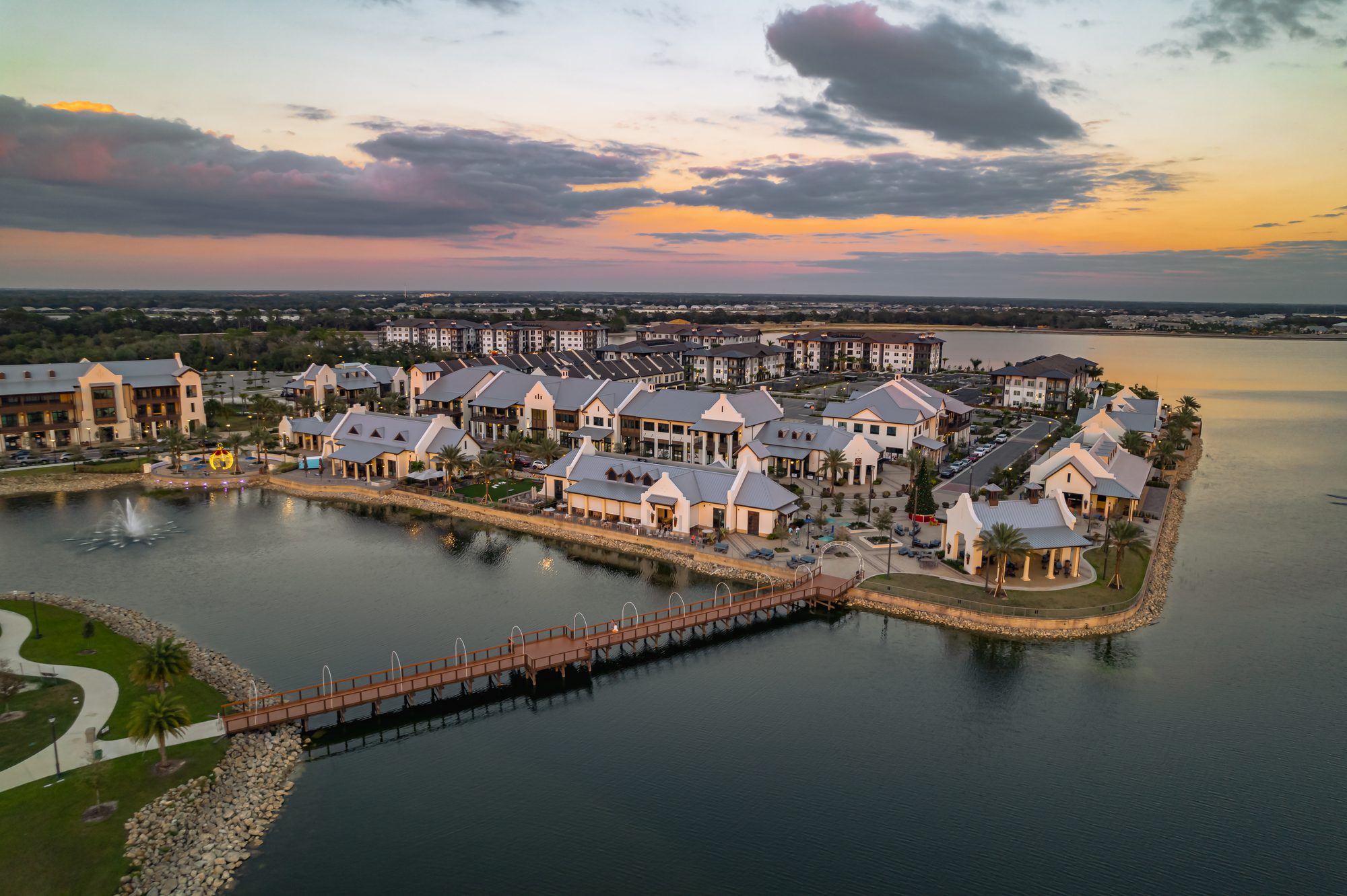 Storm-lit sunset over a lakeside Florida community, from the air